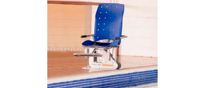 Cadeira Vollenz Aqua na cor azul sobre deck de madeira, perto da borda de uma piscina